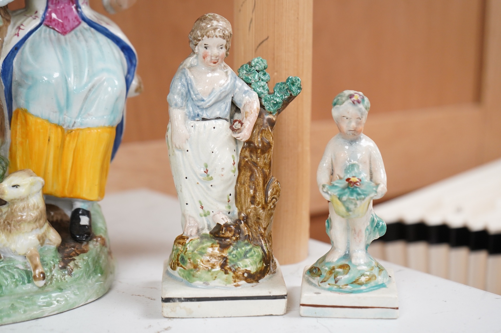 A Ralph Wood style group and three Staffordshire figures, largest 26cm high